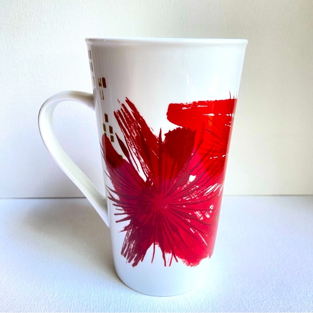Starbucks 2014 tall ceramic coffee tea mug with abstract red starbursts on white